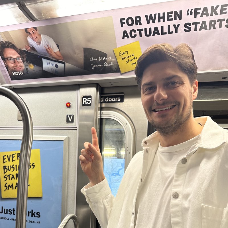 Chris next to a Koio subway ad in NYC